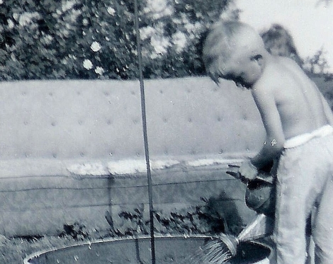 #94=Elliott watering flowers on farm, 1963 maybe